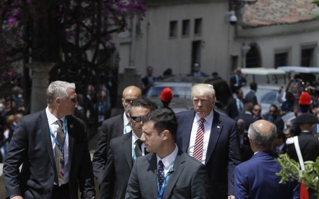 US President Donald Trump is surrounded by security guards as he arrives for a welcome ceremony for the G7 summit in the Ancient Theatre of Taormina (3rd century BC) in the Sicilian citadel of Taormina, Italy, Friday, May 26, 2017. (AP Photo/Gregorio Borgia) 
