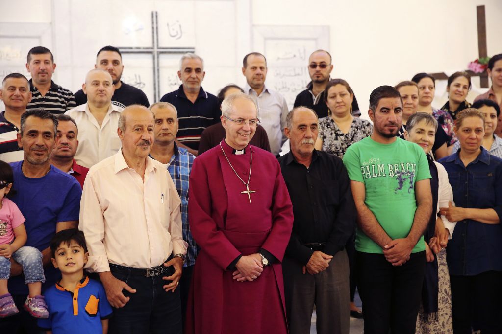 Justin Welby, center, the archbishop of Canterbury, stands with Christian refugees in Amman, Jordan on Tuesday, May 2, 2017.(AP Photo/Sam McNeil) Justin Welby, center, the archbishop of Canterbury, stands with Christian refugees in Amman, Jordan on Tuesday, May 2, 2017.(AP Photo/Sam McNeil)