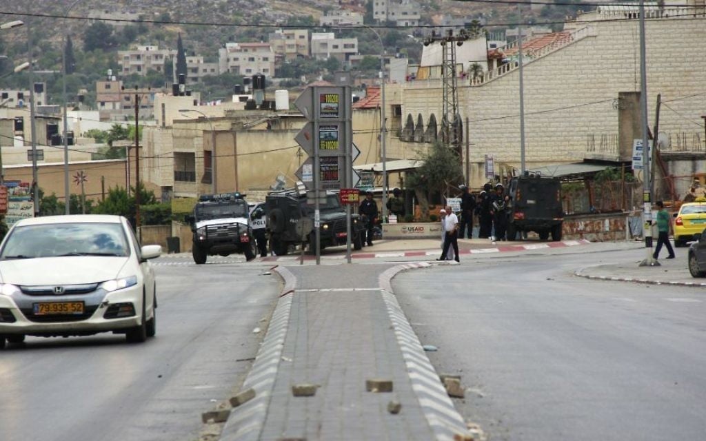 A car drives by the street where a group of Palestinians attacked an Israeli settler, who fired back, killing one person and wounding another, in Hawara, in the northern West Bank on May 19, 2017. (Judah Ari Gross/Times of Israel) A car drives by the street where a group of Palestinians attacked an Israeli settler, who fired back, killing one person and wounding another, in Hawara, in the northern West Bank on May 19, 2017. (Judah Ari Gross/Times of Israel)