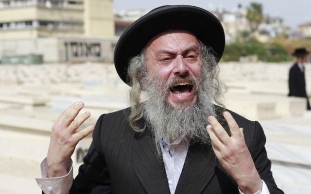 An ultra-Orthodox protester screams at the people attending a ceremony for fallen ultra-Orthodox soldiers at a cemetery in the city of Bnei Brak on May 1, 2017, Israel's Memorial Day. (Judah Ari Gross/Times of Israel) An ultra-Orthodox protester screams at the people attending a ceremony for fallen ultra-Orthodox soldiers at a cemetery in the city of Bnei Brak on May 1, 2017, Israel's Memorial Day. (Judah Ari Gross/Times of Israel)