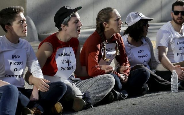 Protesters lock arms as they block a driveway at the U.S. Citizen and Immigration Services building in San Francisco, Monday, May 1, 2017. (AP/Jeff Chiu) Protesters lock arms as they block a driveway at the U.S. Citizen and Immigration Services building in San Francisco, Monday, May 1, 2017. (AP/Jeff Chiu)