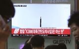 FILE - In this May 21, 2017 file photo people watch a TV news program showing a file image of a missile launch conducted by North Korea, at the Seoul Railway Station in Seoul, South Korea. (AP Photo/Ahn Young-joon, File)