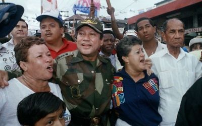 In this May 2, 1989 file photo, Gen. Manuel Antonio Noriega walks with supporters in the Chorrilo neighborhood, where he dedicated a new housing project, in Panama City. (AP/John Hopper, File)