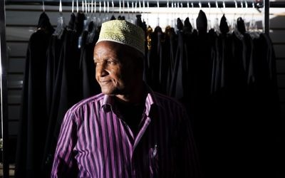 Mohamoud Saed, a refugee from Somalia, helps out in a friend's clothing store in Clarkston, Ga., Tuesday, May 2, 2017. (AP/David Goldman)