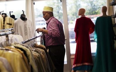 Mohamoud Saed, a refugee from Somalia, helps out in a friend's clothing store in Clarkston, Ga., Tuesday, May 2, 2017. (AP/David Goldman)