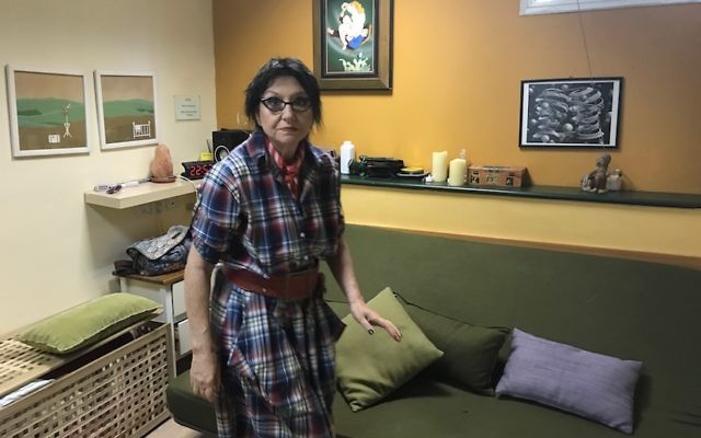 Office manager Ruta Cohn tidying up the green room at the Ronit Aloni Clinic in Tel Aviv, May 9, 2017. (Andrew Tobin via JTA) Office manager Ruta Cohn tidying up the green room at the Ronit Aloni Clinic in Tel Aviv, May 9, 2017. (Andrew Tobin via JTA)