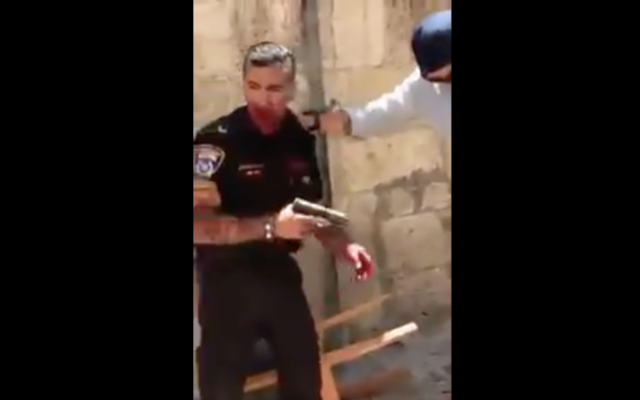 A still from footage showing a police officer after he was stabbed by an assailant on Saturday, May 13, 2017 in Jerusalem's Old City. Israel police said the attacker, a Jordanian man, was shot and died of his wounds. The policeman was hospitalized with moderate injuries. (screen capture: Quds News Network/Twitter) A still from footage showing a police officer after he was stabbed by an assailant on Saturday, May 13, 2017 in Jerusalem's Old City. Israel police said the attacker, a Jordanian man, was shot and died of his wounds. The policeman was hospitalized with moderate injuries. (screen capture: Quds News Network/Twitter)