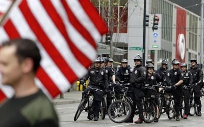 Seattle police officers on bicycles wait to follow an anti-war march by veterans during a May Day demonstration Monday, May 1, 2017. (AP/Elaine Thompson)