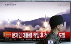 Illustrative: A South Korean army soldier walks by a TV news program showing a file image of missiles being test-launched by North Korea, at the Seoul Railway Station in Seoul, South Korea, Sunday, May 14, 2017. (AP/Ahn Young-joon)