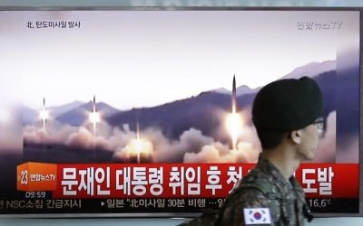 Illustrative: A South Korean army soldier walks by a TV news program showing a file image of missiles being test-launched by North Korea, at the Seoul Railway Station in Seoul, South Korea, Sunday, May 14, 2017. (AP/Ahn Young-joon)