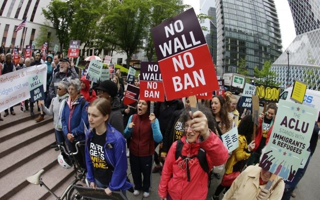 Protesters wave signs and chant during a demonstration against US President Donald Trump's revised travel ban, outside a federal courthouse in Seattle May 15, 2017. (AP/Ted S. Warren) Protesters wave signs and chant during a demonstration against US President Donald Trump's revised travel ban, outside a federal courthouse in Seattle May 15, 2017. (AP/Ted S. Warren)