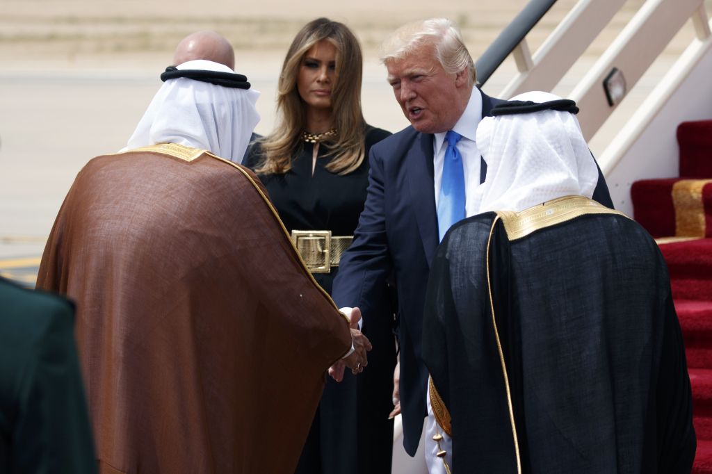 President Donald Trump, top right, accompanied by first lady Melania Trump, center, shakes hands with Saudi King Salman during a welcome ceremony at the Royal Terminal of King Khalid International Airport, Saturday, May 20, 2017, in Riyadh. (AP Photo/Evan Vucci) President Donald Trump, top right, accompanied by first lady Melania Trump, center, shakes hands with Saudi King Salman during a welcome ceremony at the Royal Terminal of King Khalid International Airport, Saturday, May 20, 2017, in Riyadh. (AP Photo/Evan Vucci)
