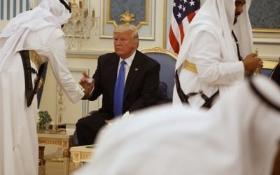 US President Donald Trump is served coffee during a presentation ceremony of The Collar of Abdulaziz Al Saud Medal at the Royal Court Palace, Saturday, May 20, 2017, in Riyadh (AP Photo/Evan Vucci)
