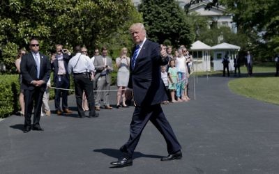 President Donald Trump gives a 'thumbs-up' as he walks back into the White House in Washington, Wednesday, May 17, 2017, following his short trip on Marine One from nearby Andrews Air Force Base, Md. (AP/Pablo Martinez Monsivais)
