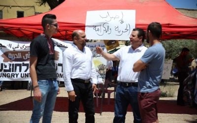 Joint (Arab) List chair Ayman Odeh (2nd right) at a solidarity tent for hunger-striking Palestinian security prisoners, in the northern Arab-Israeli city of Nazareth, May 11, 2017. (Courtesy)
