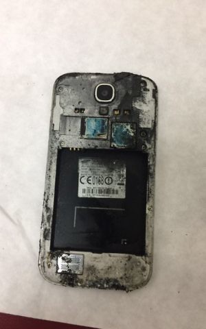 A burned Samsung cell phone suspected of combusting, injuring a boy. (David Zlotnick)