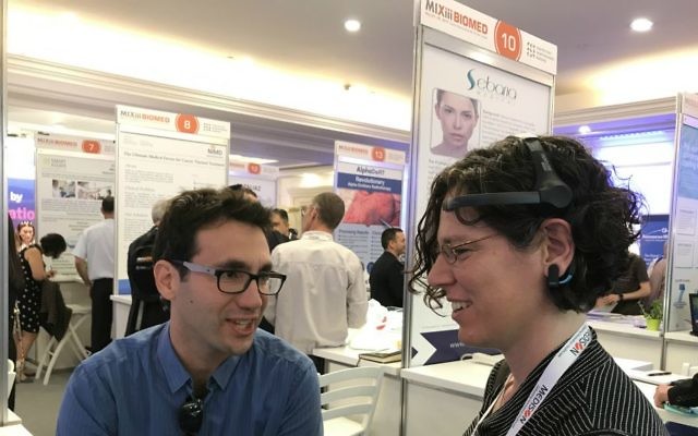 Participants at MIXiii BIOMED conference in Tel Aviv tests out BrainMARC's brain monitoring technology (Courtesy: Shoshanna Solomon)