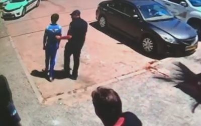 A 14-year-old boy who has apparently spent most of his life at his Hadera home is escorted out by police on May 11, 2017. (Channel 2 News)