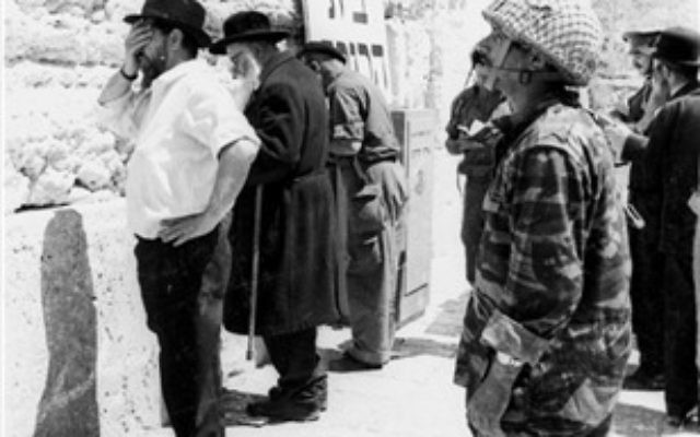 A soldier prays in front of the Western Wall, June 11, 1967. (From the collection of Dan Hadani, National Library of Israel) A soldier prays in front of the Western Wall, June 11, 1967. (From the collection of Dan Hadani, National Library of Israel)