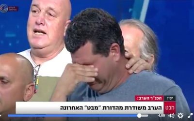 Employees of the Channel 1's Mabat news broadcast sing Hatikvah during their final news broadcast on May 9, 2017. (Screen capture/Facebook/Channel 1)