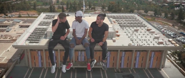 One of the virtual reality clips from the Mekudeshet video in honor of Jerusalem Day, posing three teens 'sitting' on the roof of the Knesset (Courtesy Mekudeshet) One of the virtual reality clips from the Mekudeshet video in honor of Jerusalem Day, posing three teens 'sitting' on the roof of the Knesset (Courtesy Mekudeshet)
