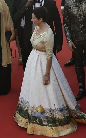 Israeli Culture Minister Miri Regev wearing a dress featuring the Old City of Jerusalem arrives on May 17, 2017 for the screening of the film 'Ismael's Ghosts' (Les Fantomes d'Ismael) during the opening ceremony of the 70th edition of the Cannes Film Festival in Cannes, southern France. / AFP PHOTO / Antonin THUILLIER