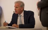 Michael Oren autographs books following a Times of Israel event in Jerusalem, May 28, 2017. (Luke Tress/Times of Israel)