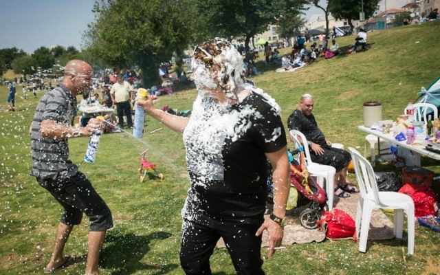 Israelis play with snow spray as they barbecue during Israel's 69th Independence Day celebrations in Sacher Park in Jerusalem, May 2, 2016. Photo by Hadas Parush/Flash90