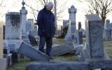 A man looks at fallen tombstones at the Jewish Mount Carmel Cemetery, February 26, 2017, in Philadelphia, PA.  (DOMINICK REUTER/AFP/Getty Images, via JTA)