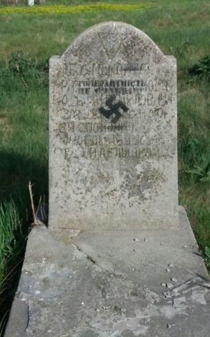 A gravestone daubed with a swastika and the words "tolerance is weakness" at the Cherkasy Jewish cemetery, Ukraine, May 5, 2017. (Courtesy)