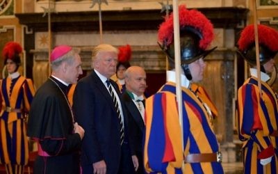 US President Donald Trump is welcomed by the prefect of the papal household Georg Gaenswein (L) as he arrives at the Vatican for a private audience with Pope Francis on May 24, 2017. / AFP PHOTO / MANDEL NGAN