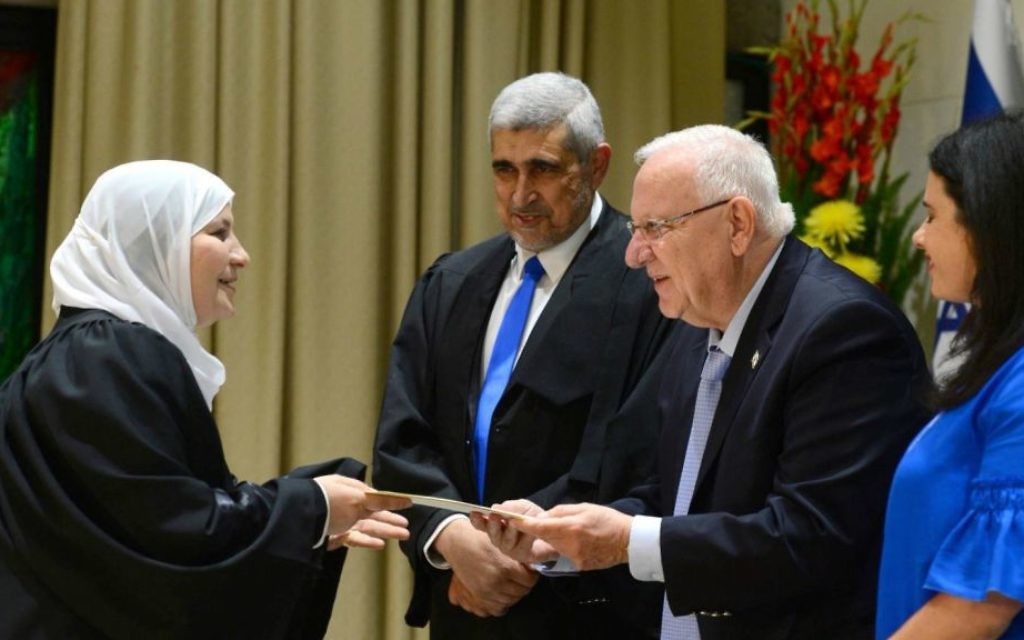 Israel's first woman sharia judge, Hana Khatib, left, is sworn in by President Reuven Rivlin, second right, at the President's Residence in Jerusalem on May 15, 2017. Justice Minister Ayelet Shaked is at right. (President's Residence Twitter account screen capture)