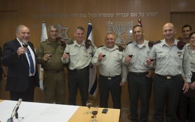 From left, Defense Minister Avigdor Liberman, Maj. Gen. (res.) Tal Russo, Maj. Gen. Yair Golan, IDF Chief of Staff Gadi Eisenkot, Maj. Gen. Aviv Kochavi and Maj. Gen. Muni Katz raise a toast at a ceremony in the army's Tel Aviv headquarters on May 11, 2017. (IDF Spokesperson's Unit)