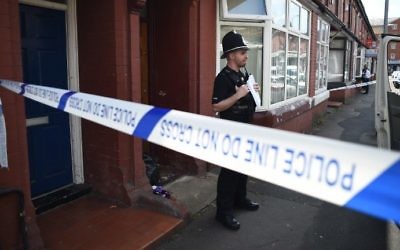 Illustrative: A Police officer stands on duty outside a residential property on Banff Road in Rusholme, Manchester, northern England on May 31, 2017, as police investigations continue into the May 22 terror attack at the Manchester Arena. (AFP PHOTO / Oli SCARFF)