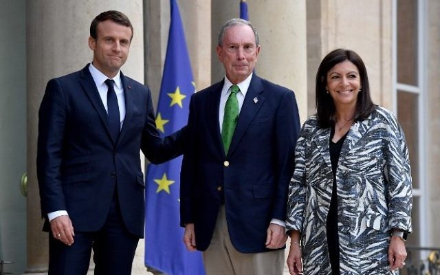 French President Emmanuel Macron, left, welcomes former mayor of New York City Michael Bloomberg flanked by Paris mayor Anne Hidalgo, right, prior their meeting at the Elysee Palace in Paris, on June 2, 2017. (AFP/Christophe Petit Tesson) French President Emmanuel Macron, left, welcomes former mayor of New York City Michael Bloomberg flanked by Paris mayor Anne Hidalgo, right, prior their meeting at the Elysee Palace in Paris, on June 2, 2017. (AFP/Christophe Petit Tesson)