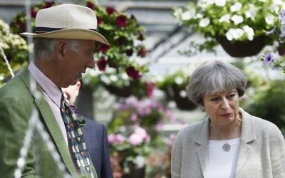Britain's Prime Minister Theresa May (R) seen during a campaign visit to Horsfields Nursery in Silkstone, South Yorkshire on June 3, 2017. (AFP Photo/Pool/Hannah McKay) 