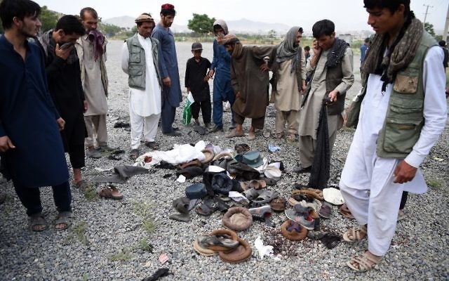 Afghan men stand over the belongings of blast victims at the site of a series of explosions that targeted a funeral of a politician's son, who was killed during an anti-government protest a day earlier, at Badam Bagh in Kabul on June 3, 2017 ( AFP PHOTO / WAKIL KOHSAR) Afghan men stand over the belongings of blast victims at the site of a series of explosions that targeted a funeral of a politician's son, who was killed during an anti-government protest a day earlier, at Badam Bagh in Kabul on June 3, 2017 ( AFP PHOTO / WAKIL KOHSAR)