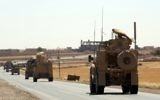 US-made armored vehicles are seen on a road near the northern Syrian village of Ain Issa on June 3, 2017. (AFP PHOTO / DELIL SOULEIMAN)