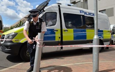 A police officer creates a cordon on Kings Road in Barking, east London on June 4, 2017, as police continue their investigations following the June 3 terror attacks in central London. (AFP PHOTO / Justin TALLIS)