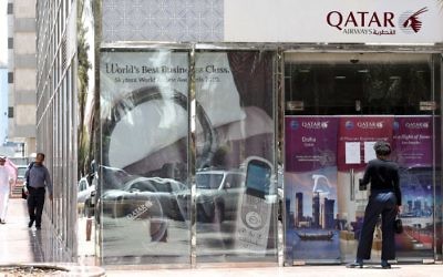 A man stands outside the Qatar Airways branch in the Saudi capital Riyadh, after the airline had suspended all flights to Saudi Arabia following a severing of relations between major gulf states and gas-rich Qatar, June 5, 2017. (AFP/FAYEZ NURELDINE)