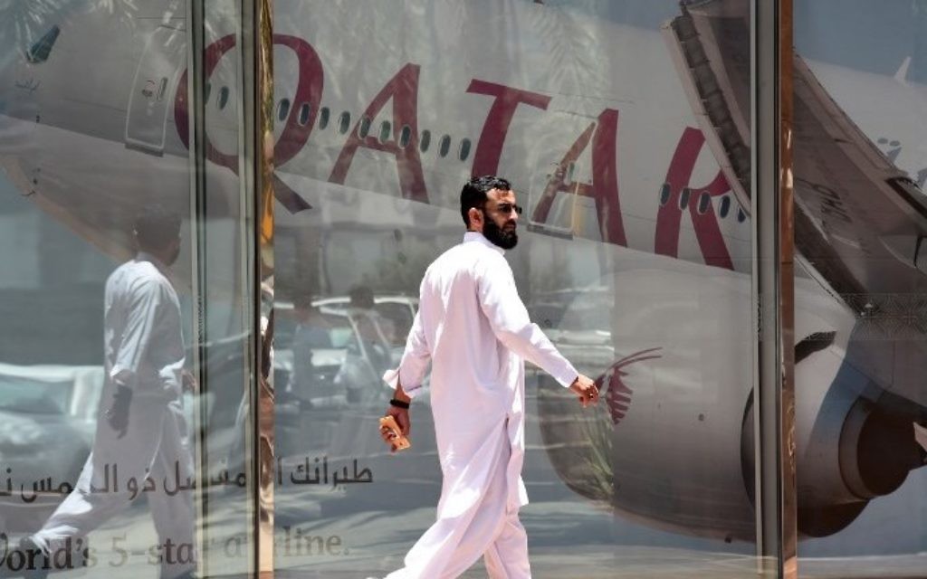 A man walking past the Qatar Airways branch in the Saudi capital Riyadh, after it had suspended all flights to Saudi Arabia following a severing of relations between major gulf states and gas-rich Qatar, June 5, 2017. (AFP/FAYEZ NURELDINE)