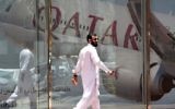 A man walking past the Qatar Airways branch in the Saudi capital Riyadh, after it had suspended all flights to Saudi Arabia following a severing of relations between major gulf states and gas-rich Qatar, June 5, 2017. (AFP/FAYEZ NURELDINE)