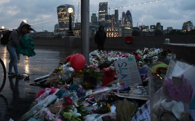A woman looks at flowers laid at Potters Fields Park in London on June 5, 2017, after a vigil to commemorate the victims of the terror attack on London Bridge and at Borough Market that killed seven people on June 3. (AFP PHOTO / Chris J Ratcliffe) A woman looks at flowers laid at Potters Fields Park in London on June 5, 2017, after a vigil to commemorate the victims of the terror attack on London Bridge and at Borough Market that killed seven people on June 3. (AFP PHOTO / Chris J Ratcliffe)