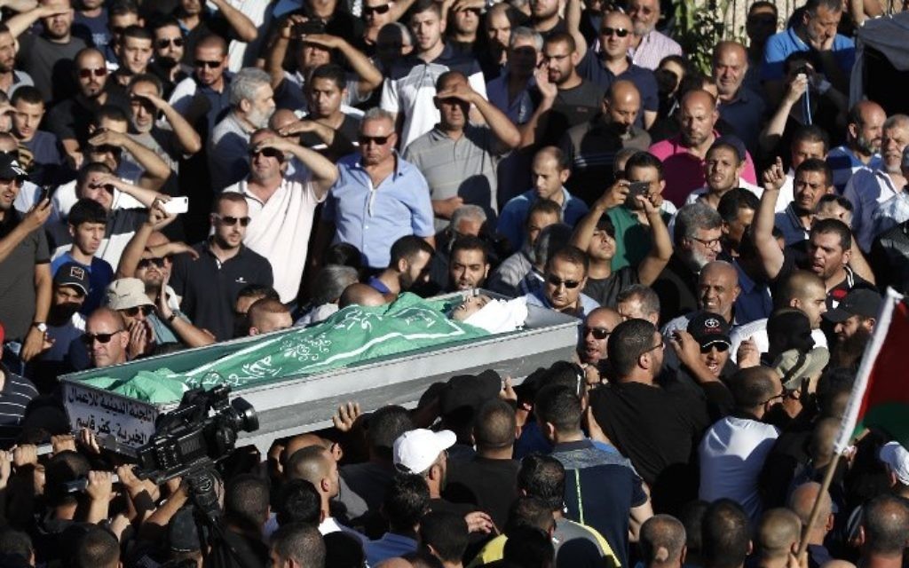 Mourners carry the body of Mohammed Taha, who was killed during clashes as protesters attempted to storm a police station overnight, during his funeral in the Arab city of Kfar Qassem in central Israel, on June 6, 2017. (AFP PHOTO / Ahmad GHARABLI)