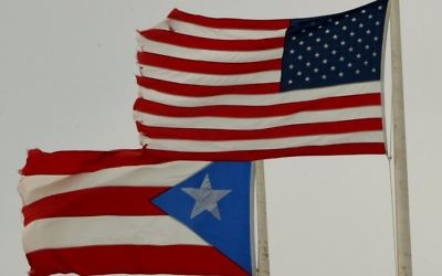 This photo taken on May 08, 2017 shows the flags of Puerto Rico and the US flying side-by-side on May 8, 2017 in San Juan, Puerto Rico. (Mark RALSTON / AFP) This photo taken on May 08, 2017 shows the flags of Puerto Rico and the US flying side-by-side on May 8, 2017 in San Juan, Puerto Rico. (Mark RALSTON / AFP)