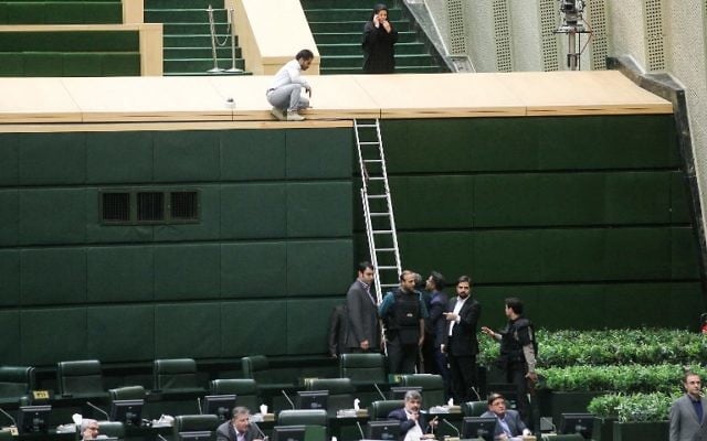 A picture taken on June 7, 2017 shows policemen deploying in the main hall of Iranian parliament to protect lawmakers during the attack which targeted the complex on June 7, 2017. (AFP/CHAVOSH HOMAVANDI)