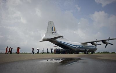 This photo taken on August 5, 2015 shows a Myanmar Air Force Shaanxi Y-8 transport aircraft being unloaded at Sittwe airport in Rakhine state, similar to the aircraft carrying over 100 people that went missing between the southern city of Myeik and Yangon on June 7, 2017. (AFP PHOTO / Ye Aung Thu)