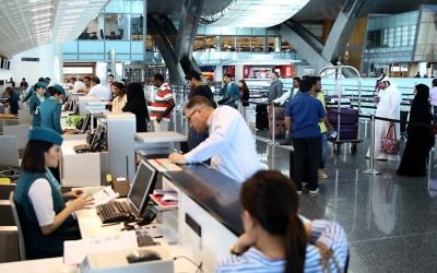 Passengers check-in at the Hamad International Airport in Doha on June 7, 2017. (AFP/STRINGER)