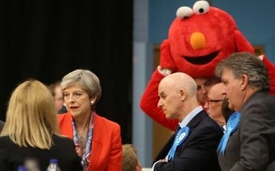 British Prime Minister Theresa May (2nd L) waits for the results to be declared at the count centre in Maidenhead early in the morning of June 9, 2017, hours after the polls closed in Britain's general election. (AFP PHOTO / Geoff CADDICK)
