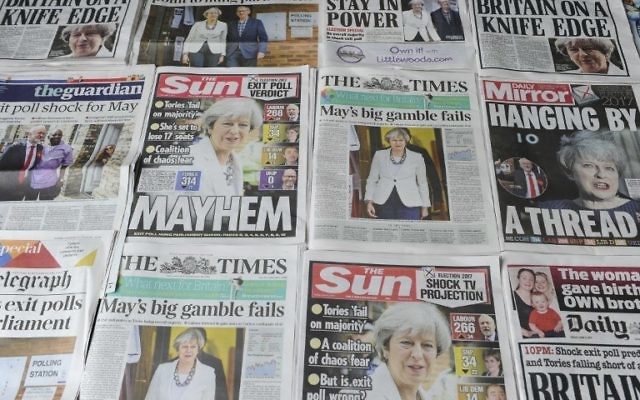 An arrangement of British daily newspapers are photographed as an illustration in London on June 9, 2017 showing front page stories about the exit poll results of the snap general election. (AFP PHOTO / DANIEL SORABJI)